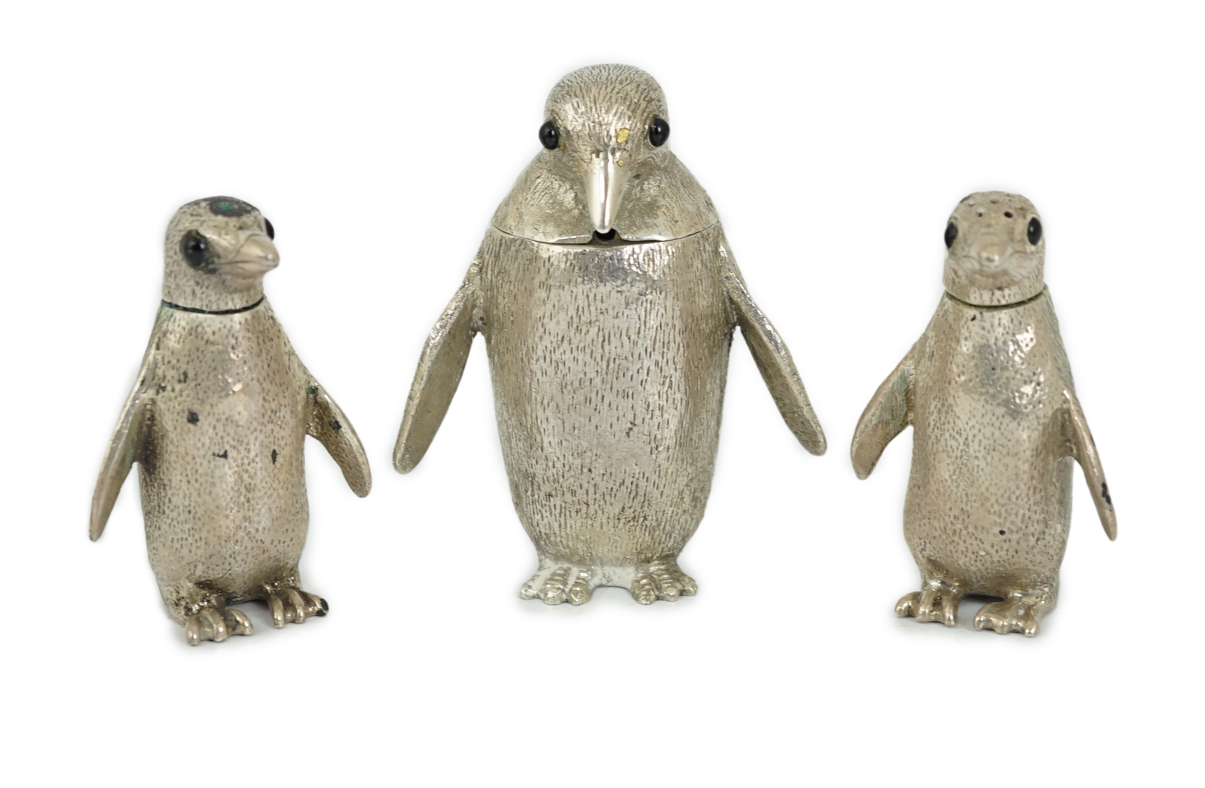 An Elizabeth II graduated suite of three novelty silver condiments, modelled as penguins, by William Comyns & Sons Ltd